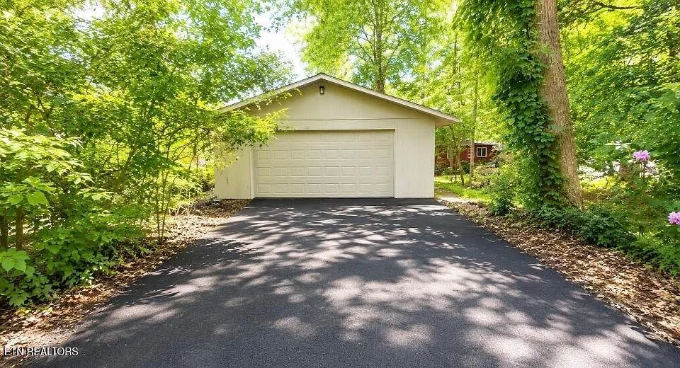 The detached garage at the top of the paved drive
