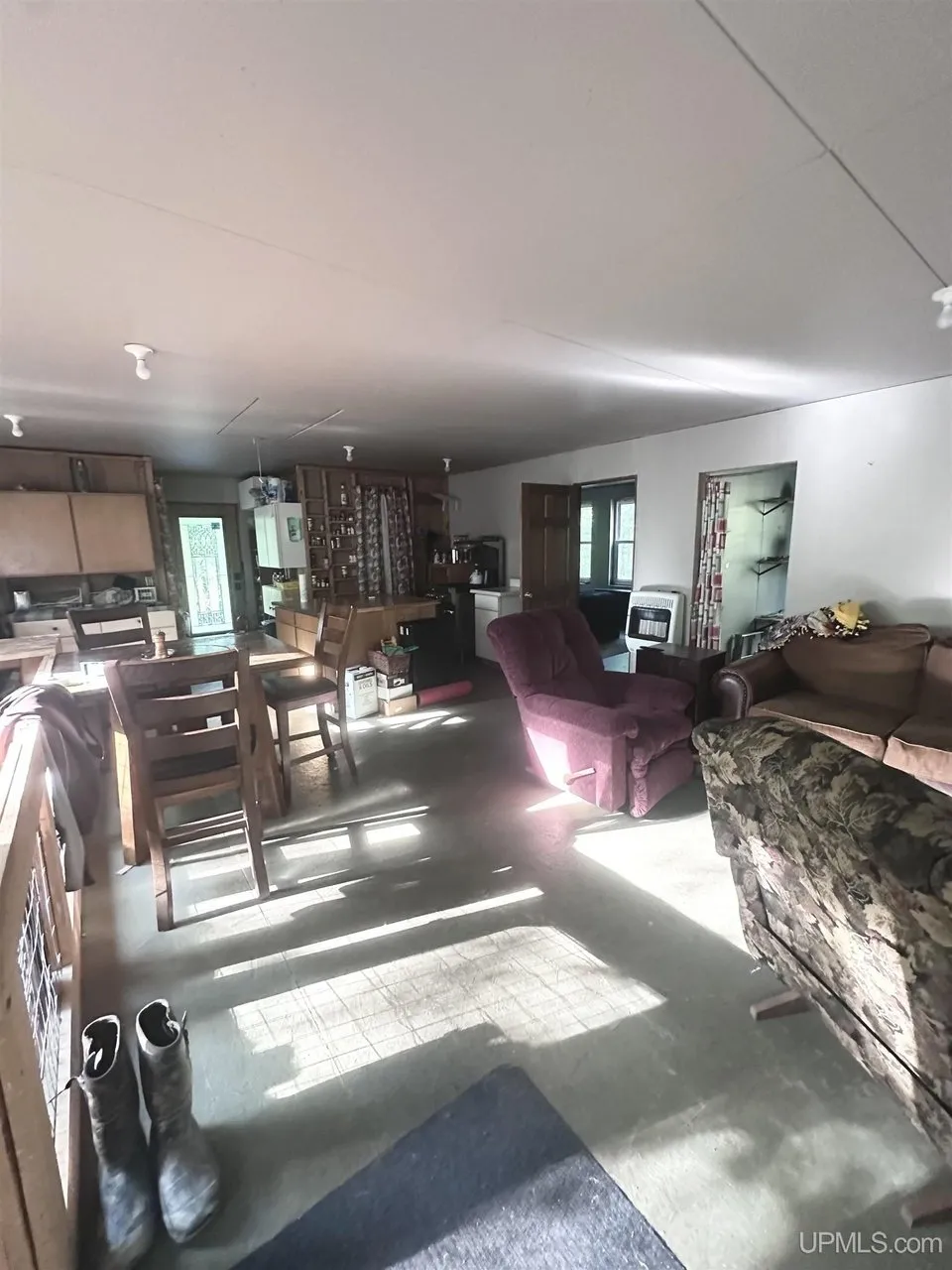The living and dining area with the table and the windows