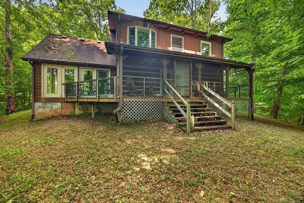 The back of the home with its screened porch and upper deck