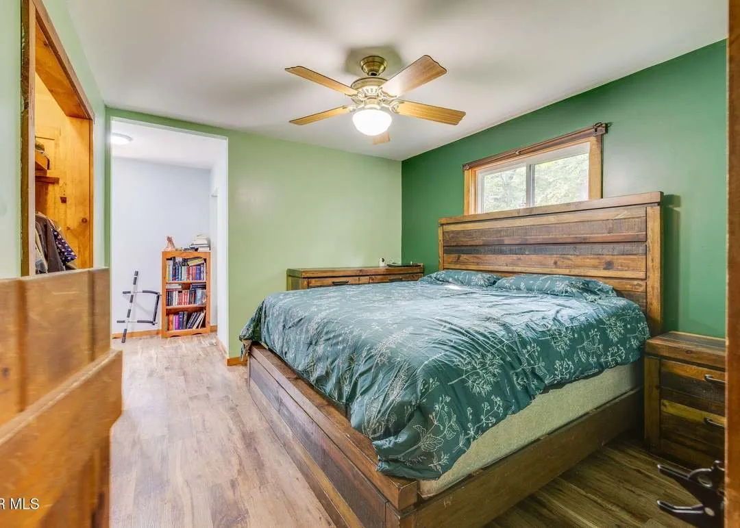 A main-level bedroom with wood trim and natural light