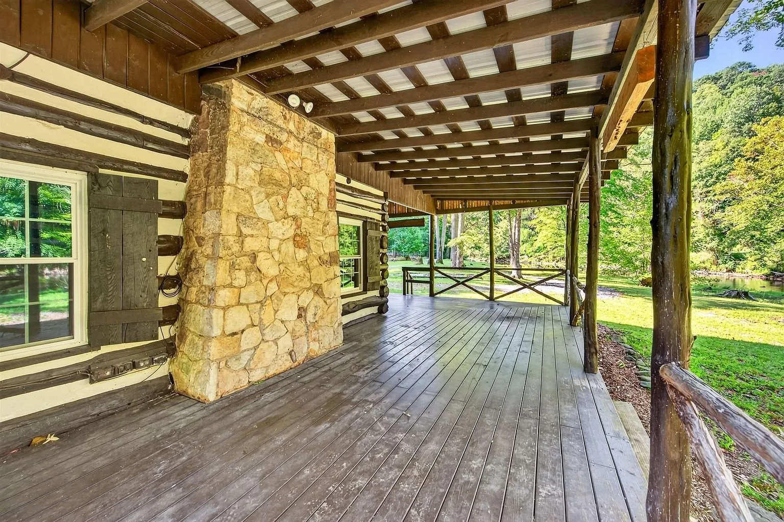 The stone chimney rising through the porch roof
