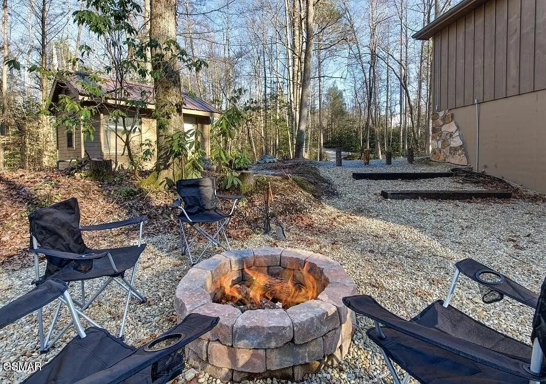 The stone fire pit ring with camp chairs on the gravel pad
