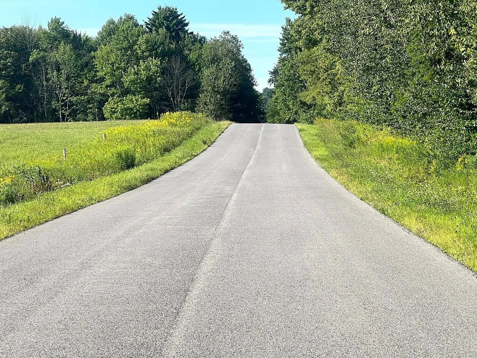Vanburen Road, paved, running between fields and woods