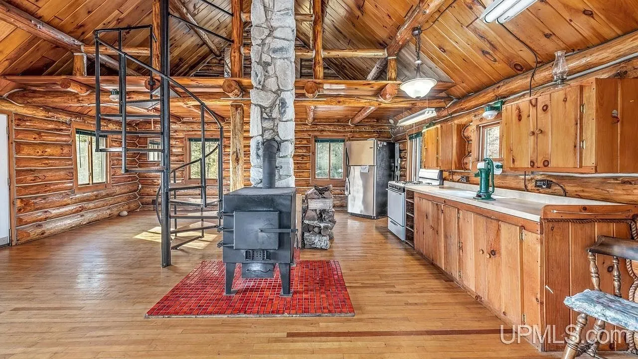 The kitchen and dining area with the spiral staircase to the loft