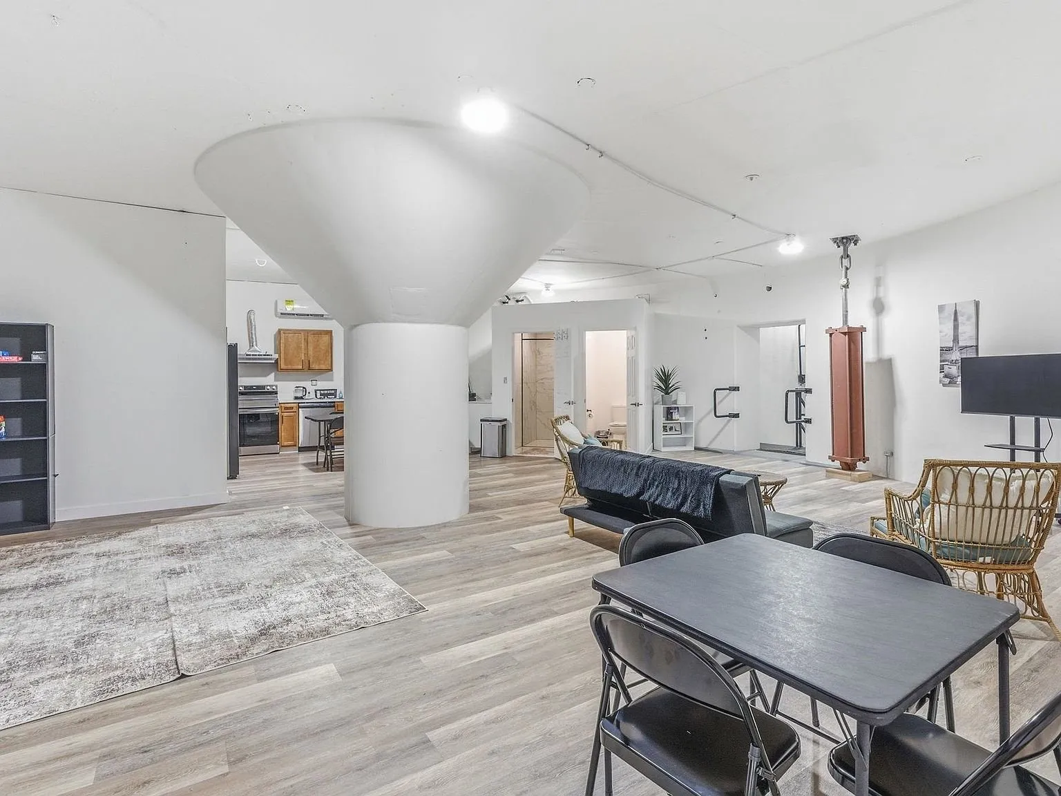 The kitchen with wood cabinets, stainless appliances and a dining table