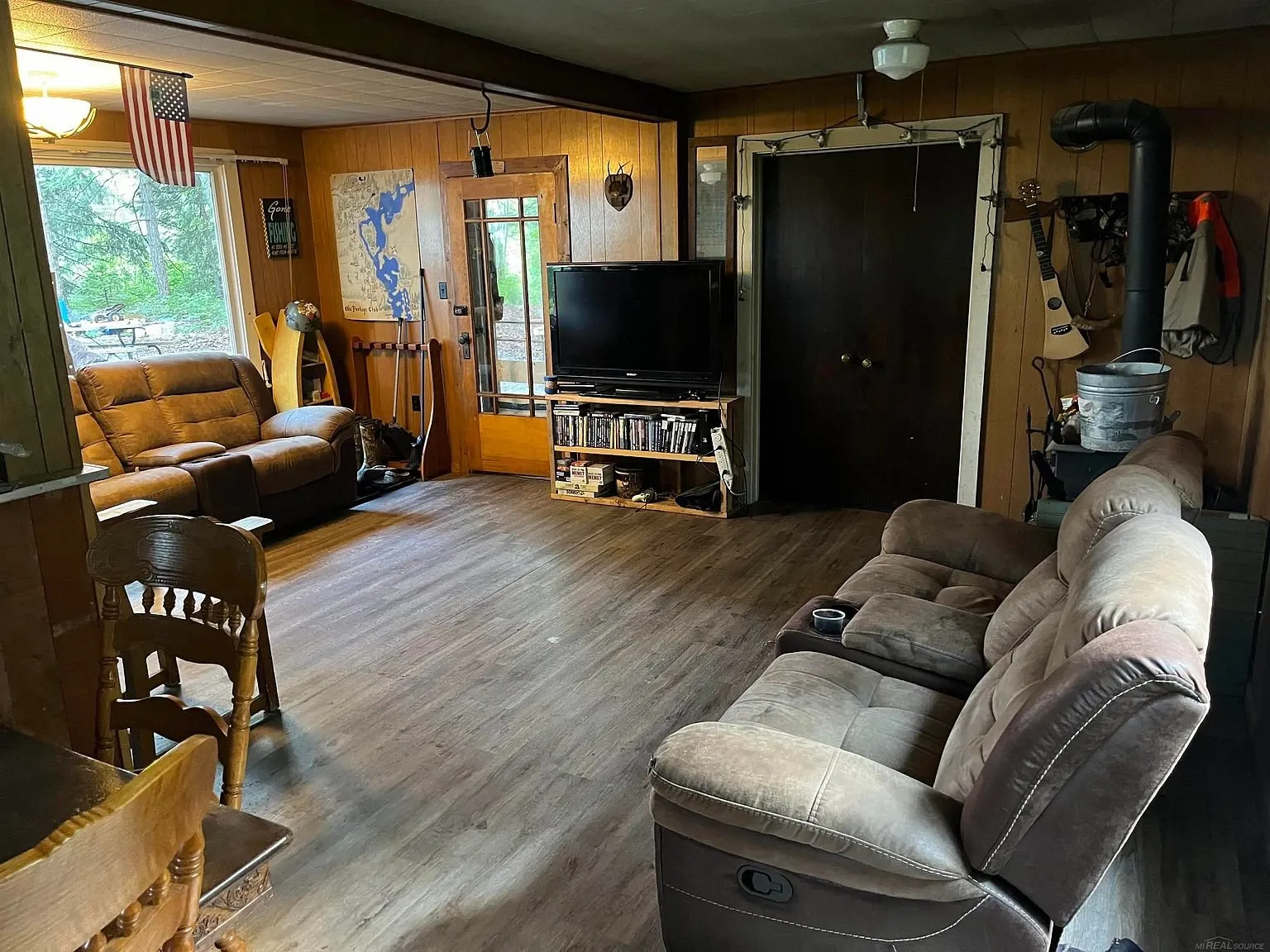 The main room with the recliners, the television and the door