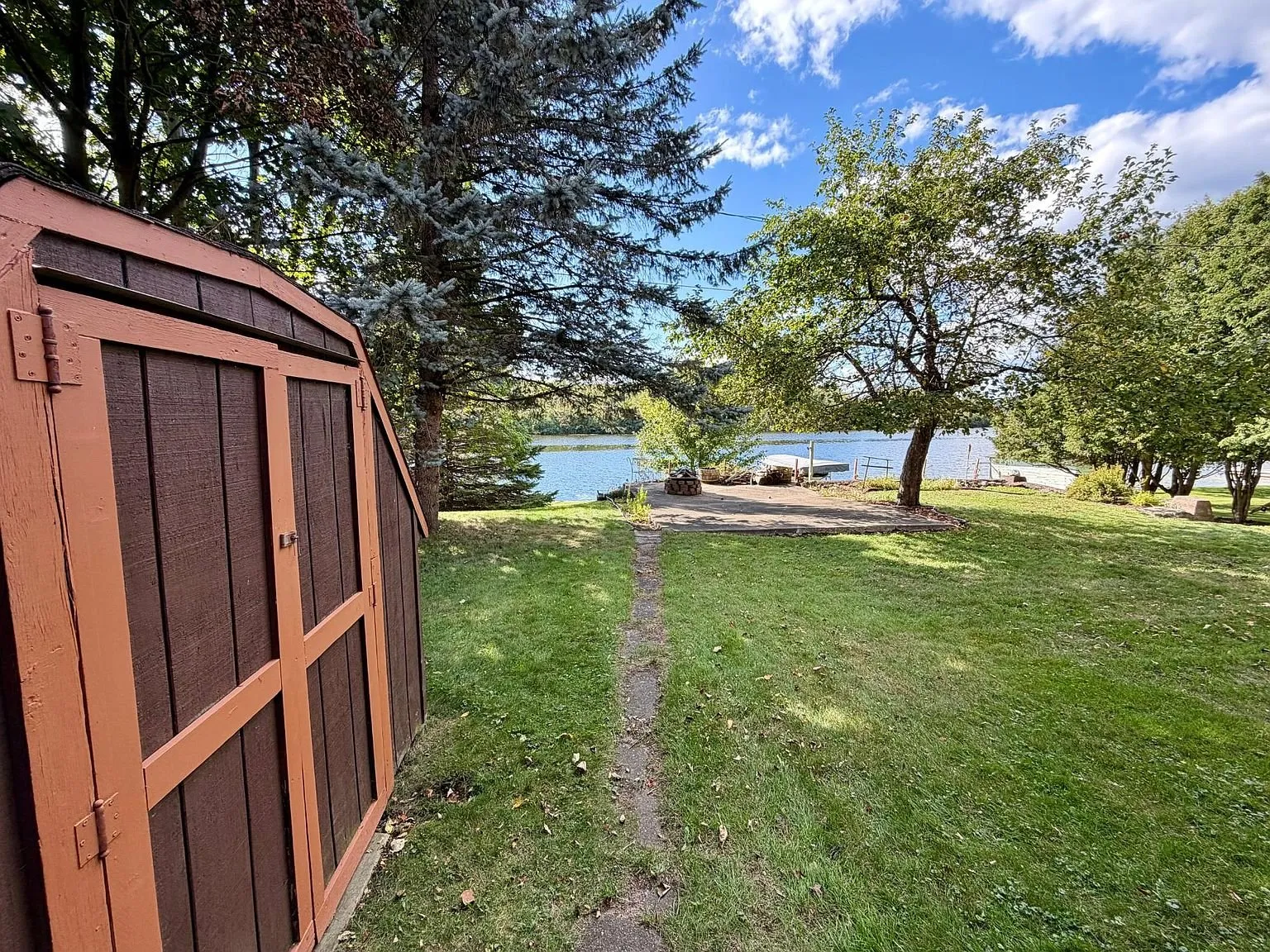 The shed with the path down the lawn to the water