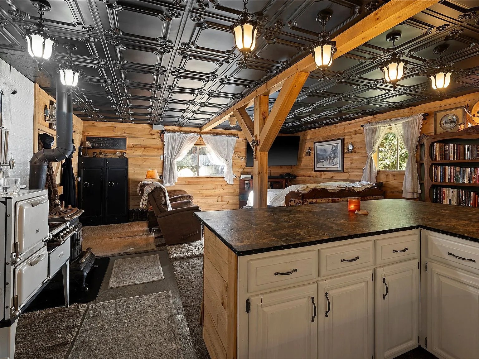 A built-in desk and reading chair nook along the cabin's wood-paneled wall