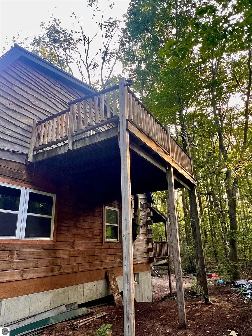 The balcony on its posts over the yard