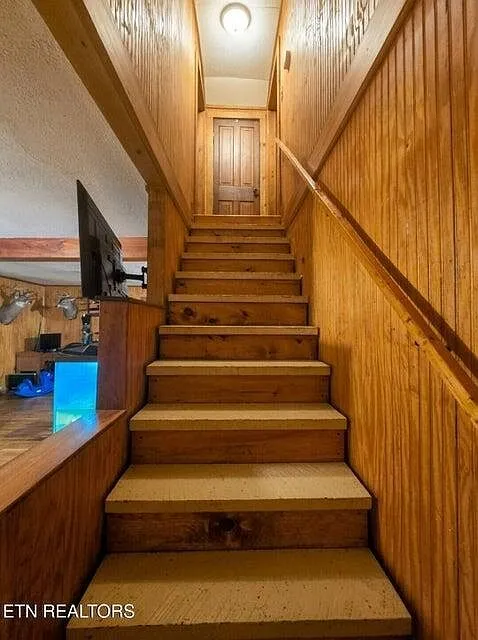 The wood staircase leading up to the second-floor bedrooms