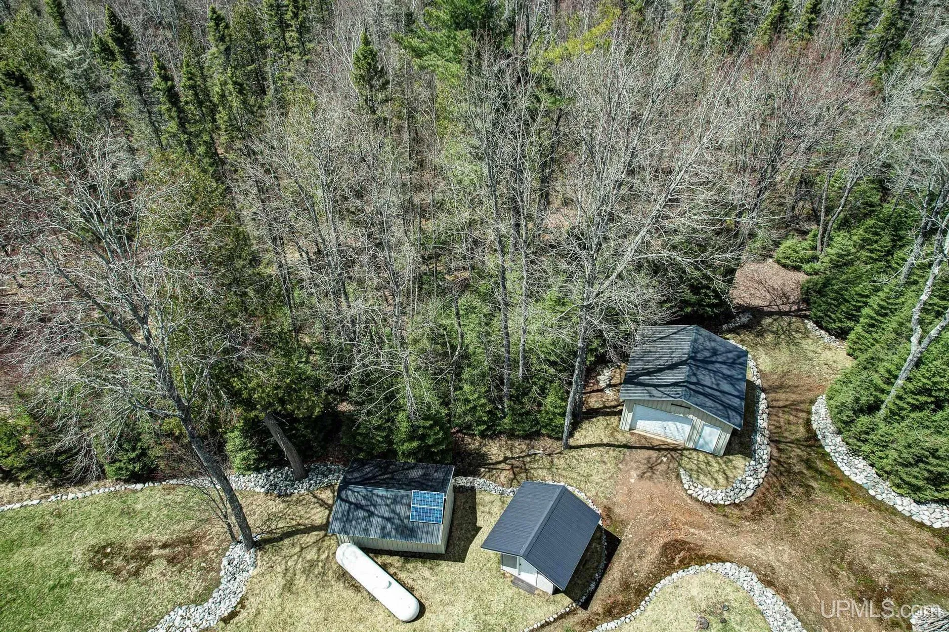 Aerial of the cabin, garage and sheds from the side