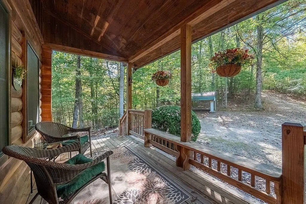The side porch with chairs looking out into the woods