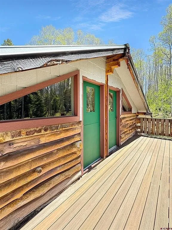 The upper deck with the green door and the aspens