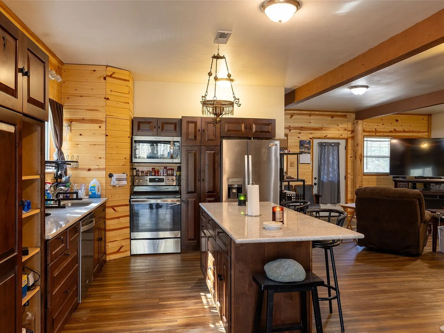 A second kitchen island with quartz counters and bar stools