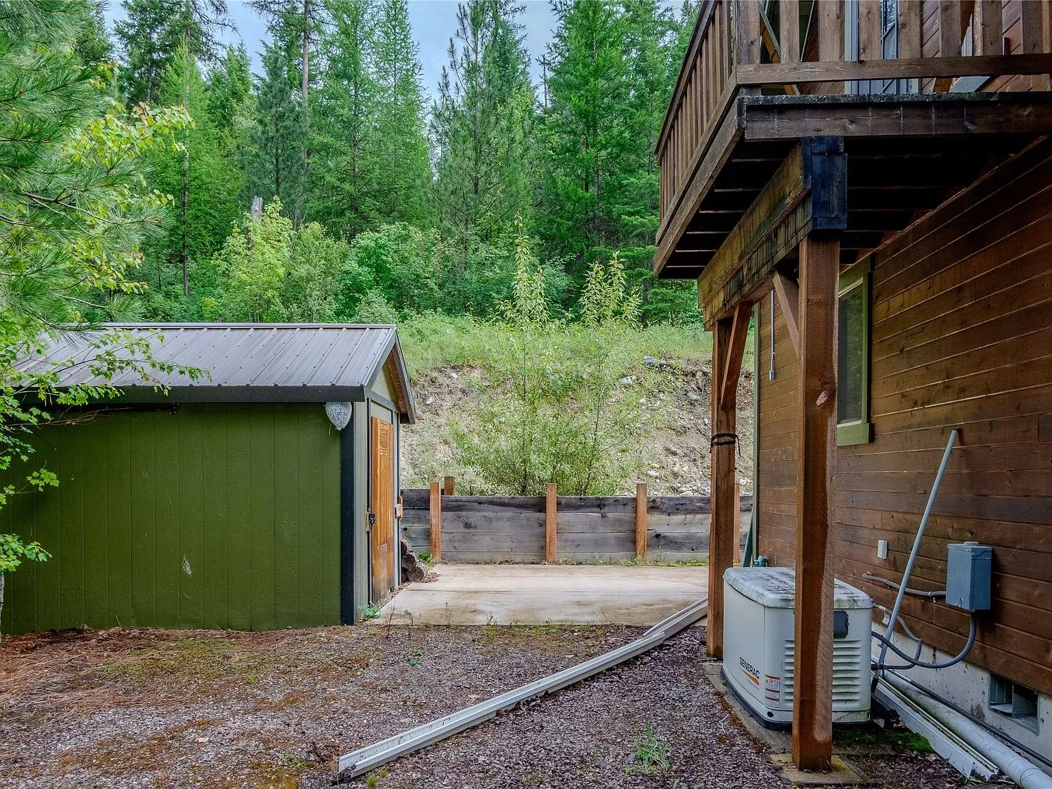 The second storage shed and lower-level utility area beneath the upper balcony