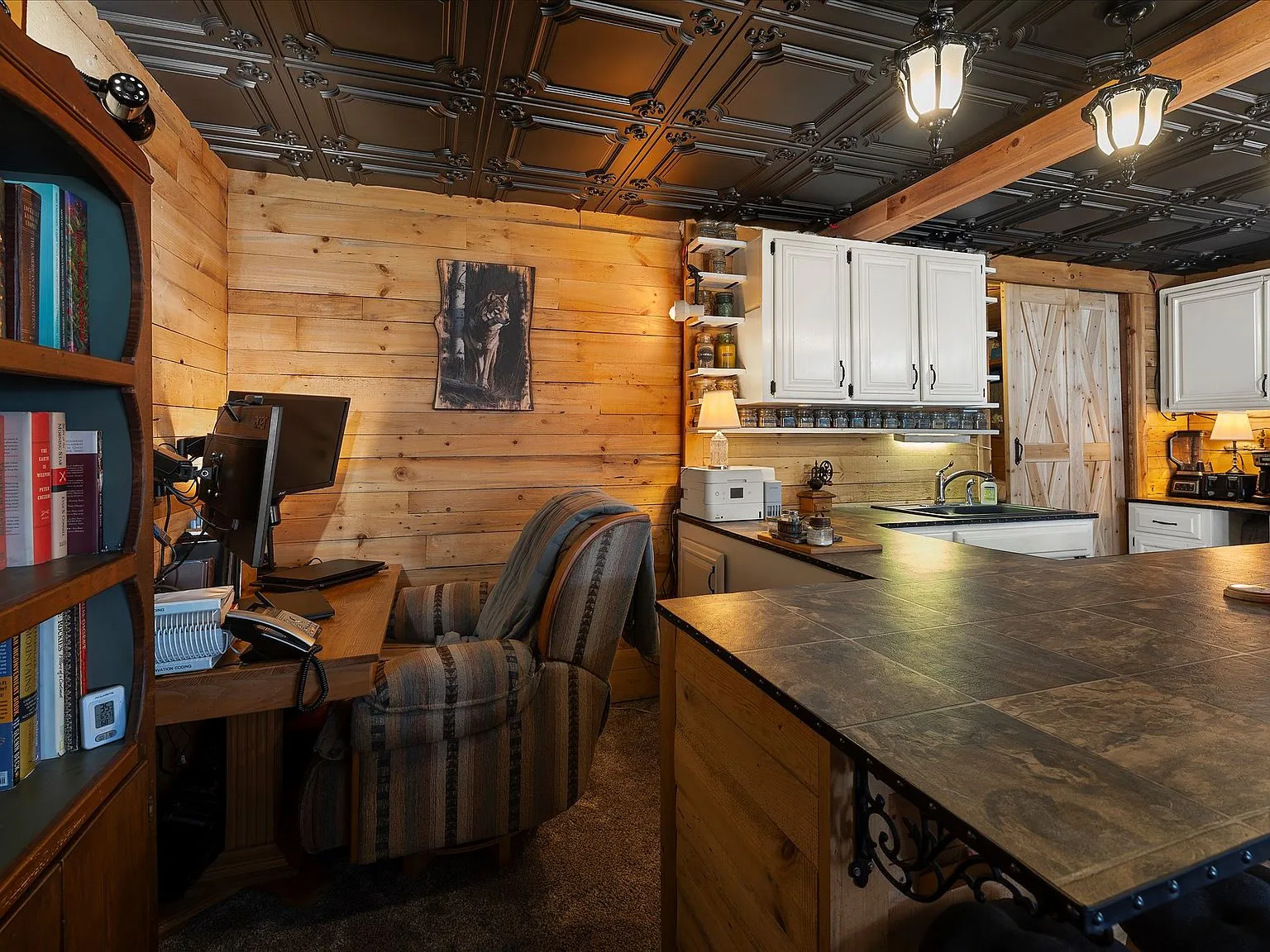 The kitchen with white cabinets, an antique propane range and an off-grid refrigerator