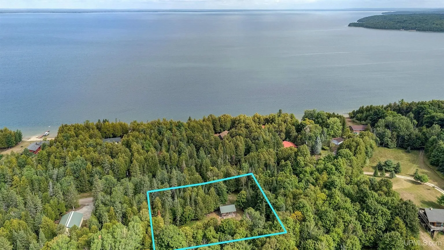 Aerial with the lot outlined, set back from Lake Michigan behind two rows of houses and a road