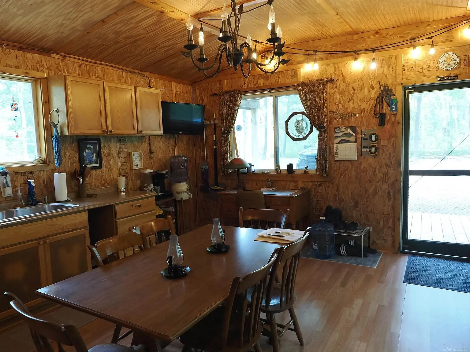 The kitchen counter, the table and the door onto the porch