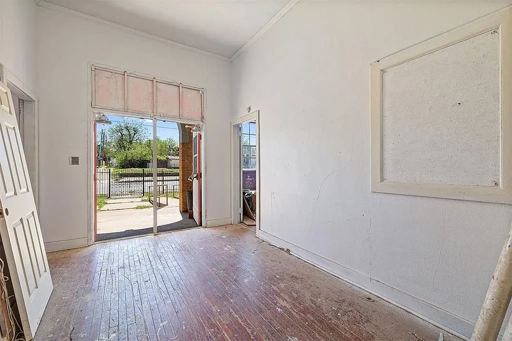 Inside the front doors with the hardwood floor and the transom