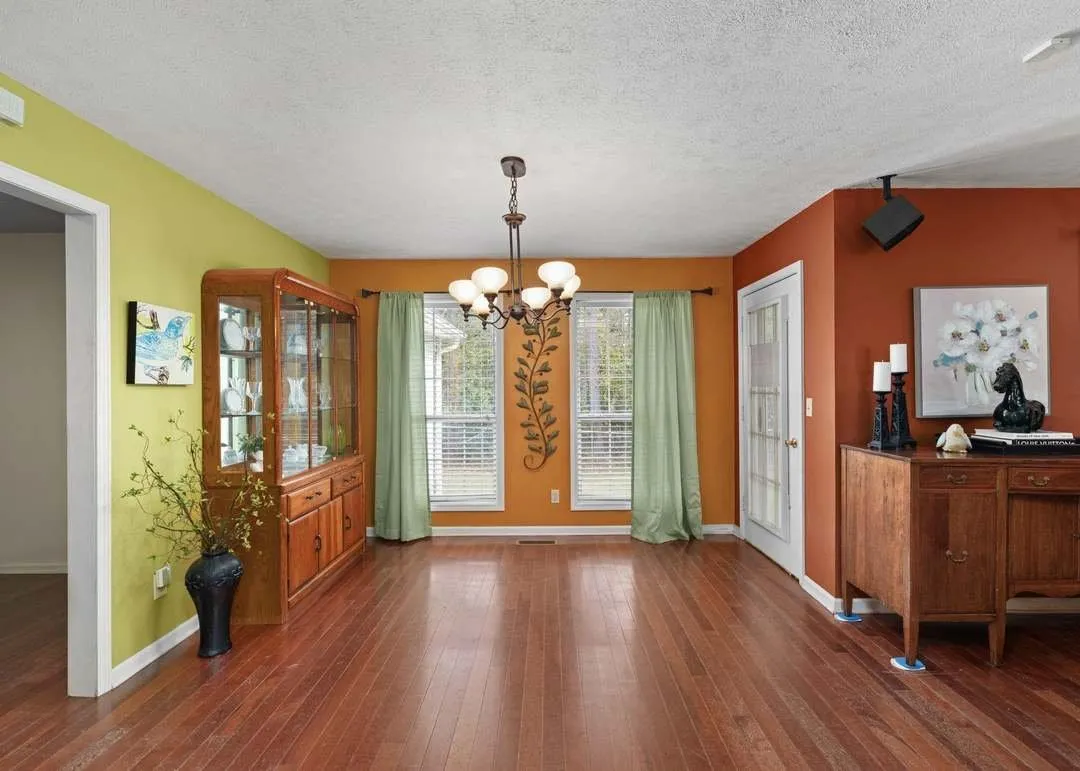 The formal dining room with a built-in china cabinet and chandelier
