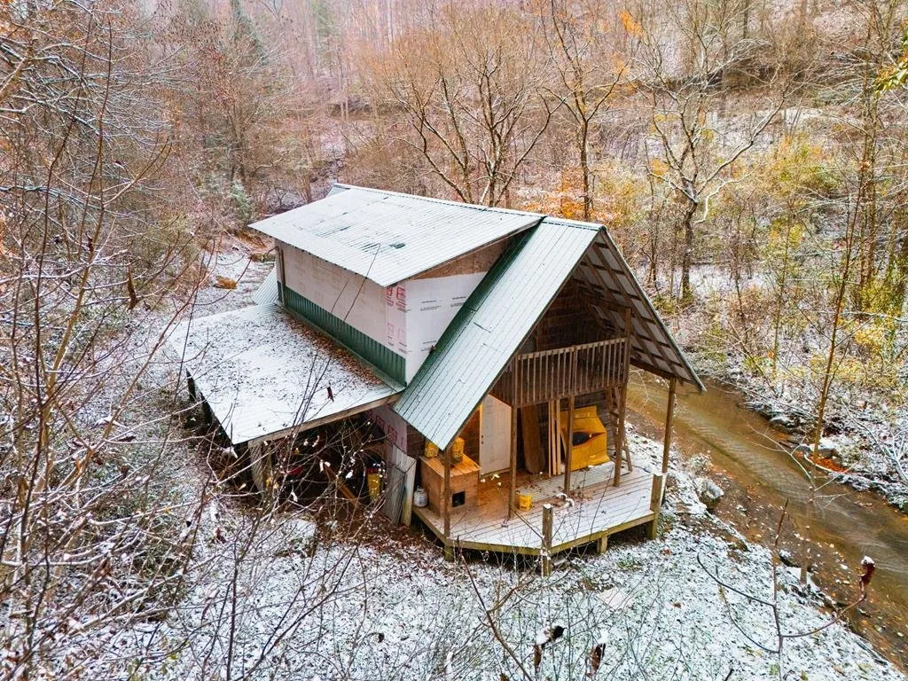 Aerial straight down on the cabin's roof and deck in the snow