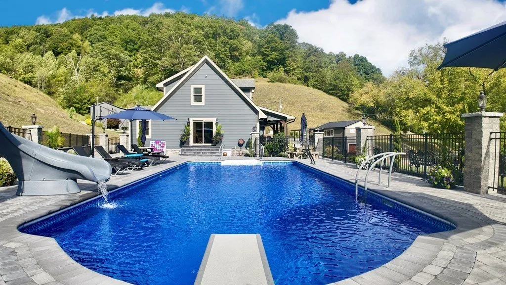 The pool looking toward the house, water blue against the stone