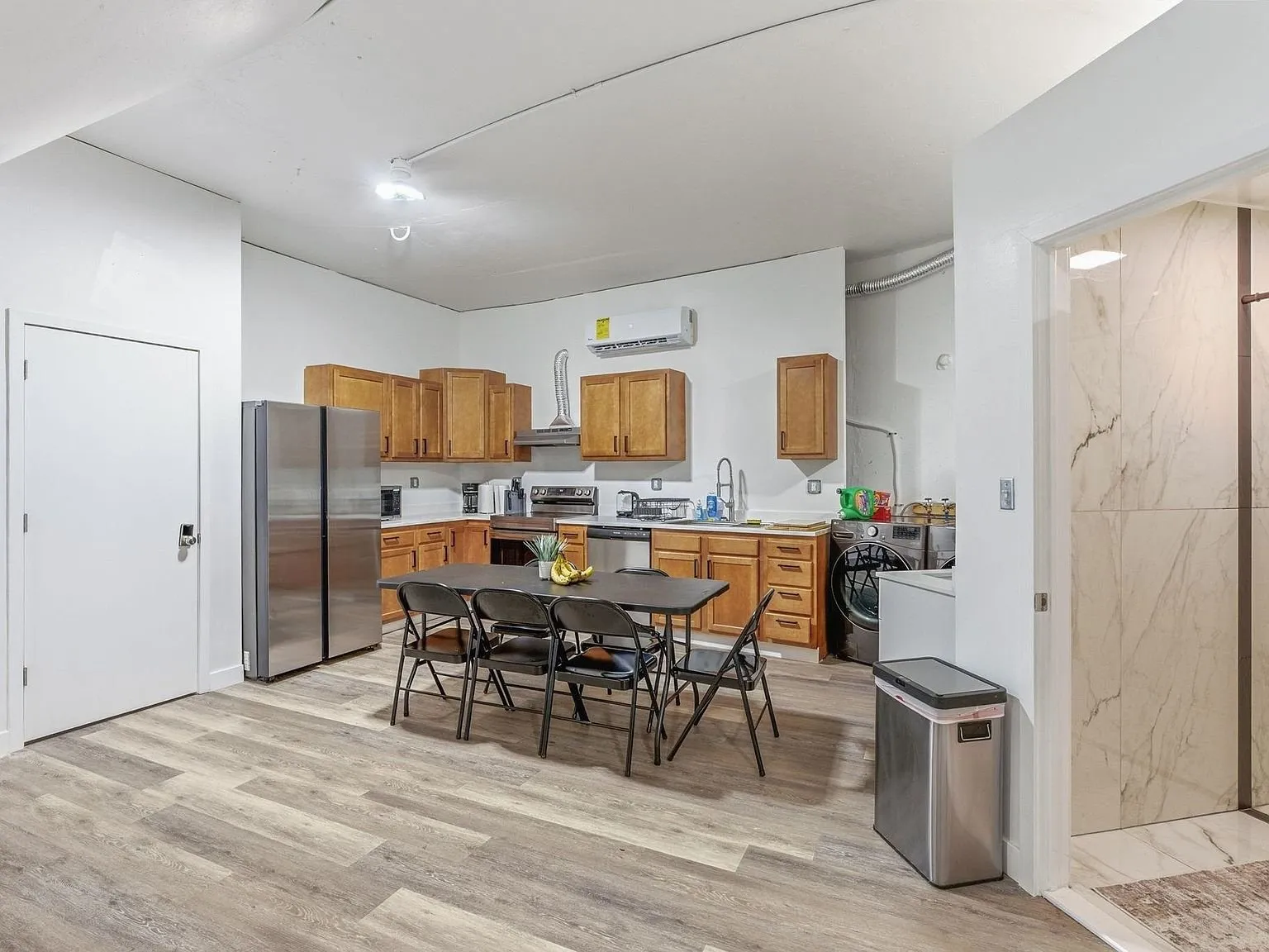 A second view of the kitchen with its counters and overhead cabinets