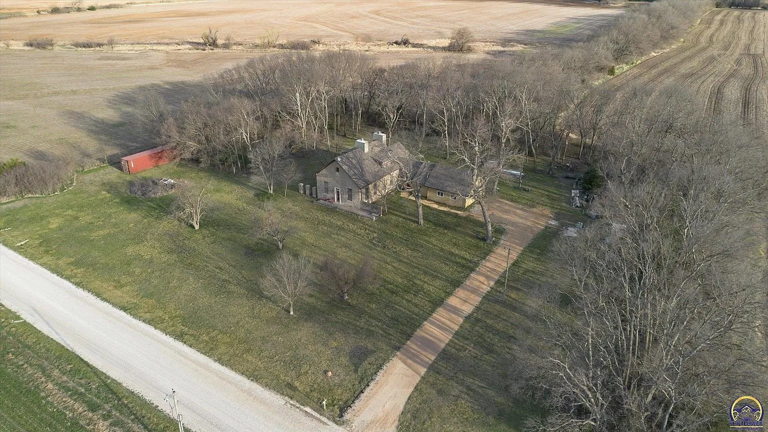 The lot from the air with the house, the drive and the road