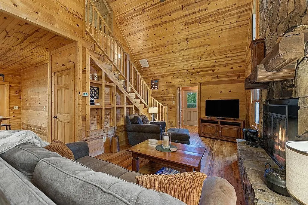 The great room's seating area with the stairs to the loft bedroom