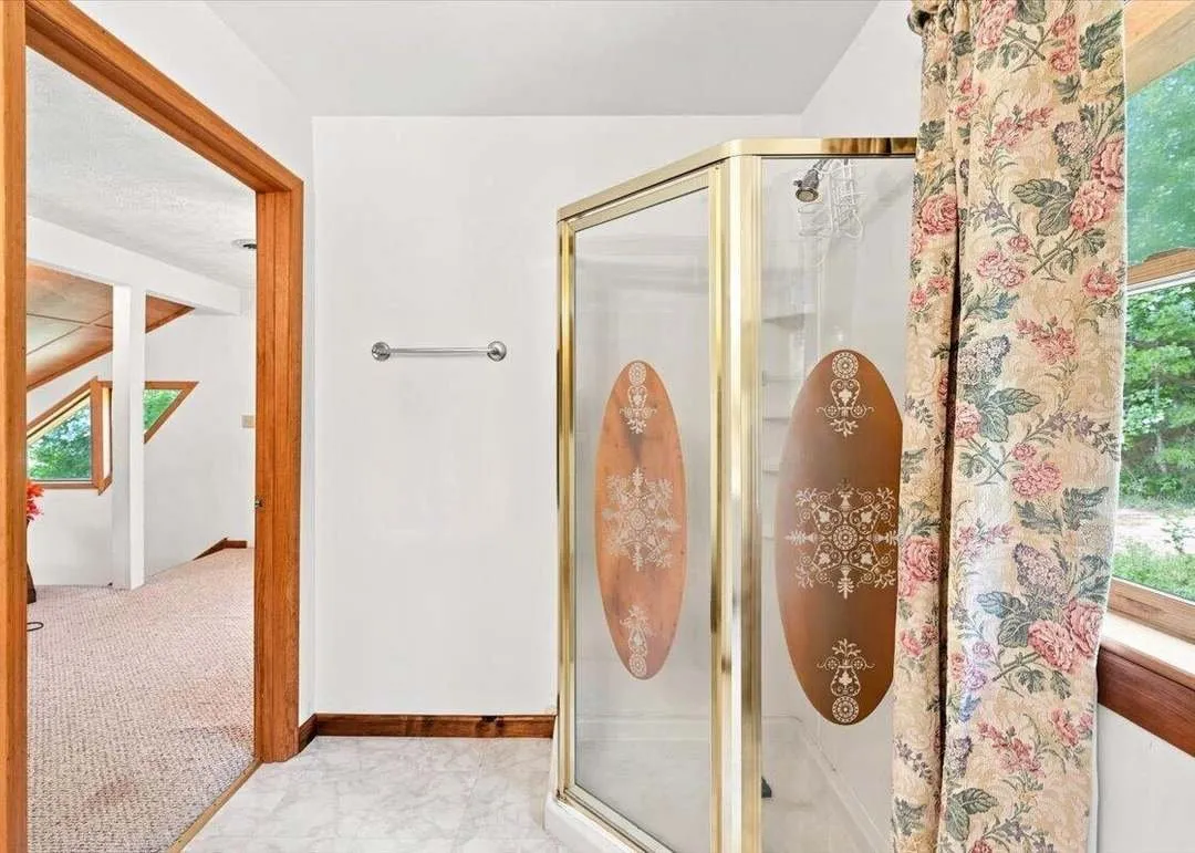 The basement's own full bathroom, with a glass-enclosed shower
