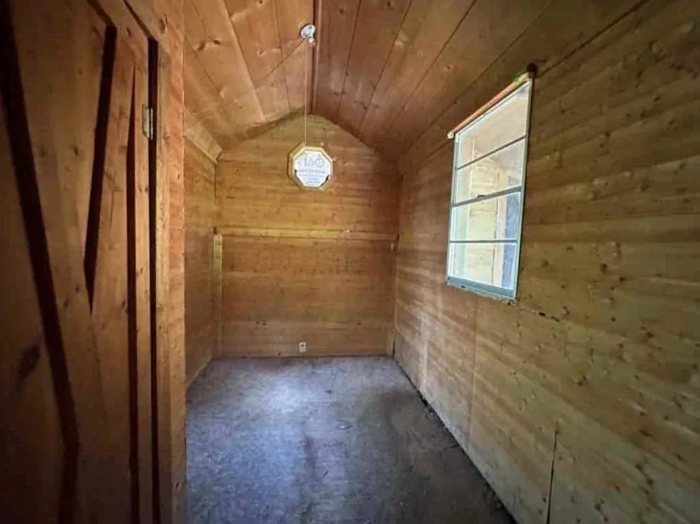 A wood-paneled entry room with glass-paned doors and a tiled floor