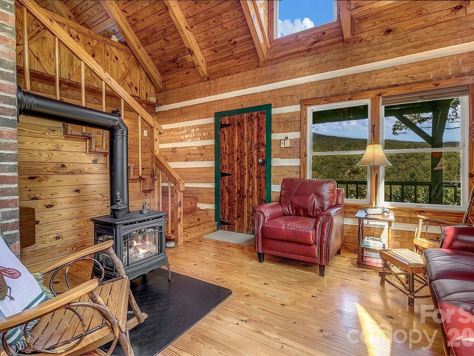 The living room with a leather armchair facing the gas stove