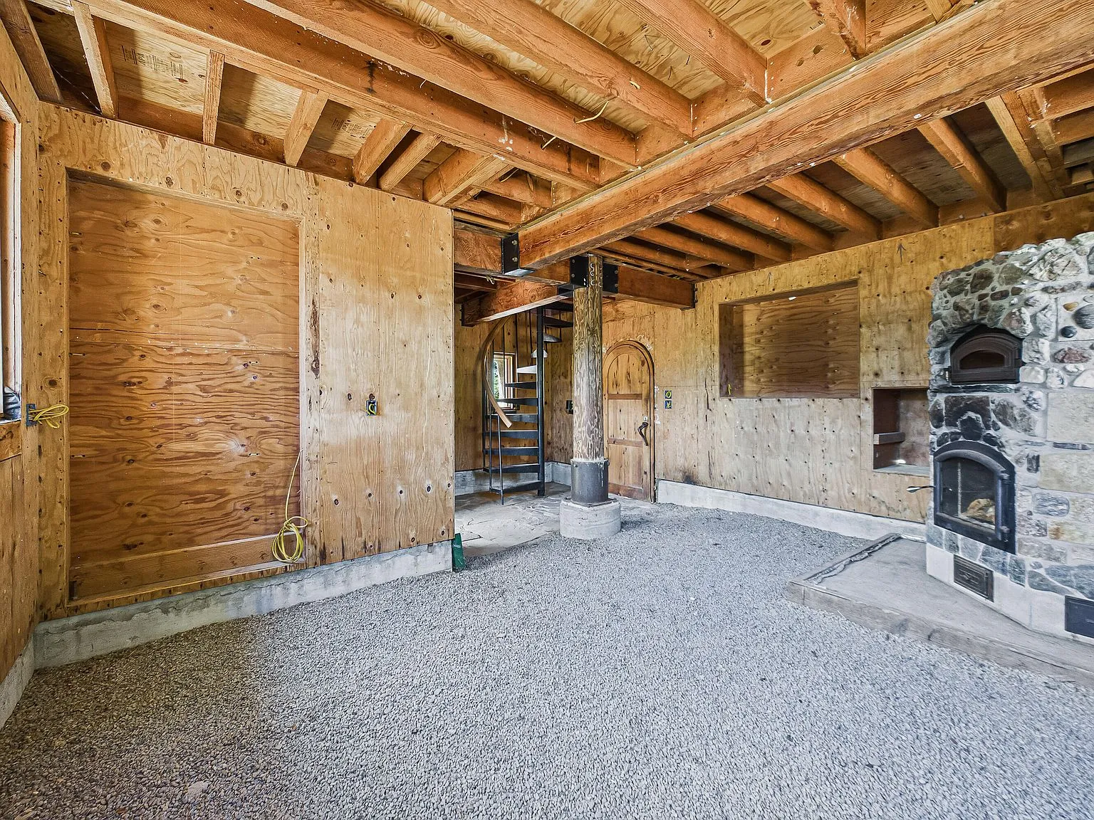 A second view of the masonry heater and open framing from across the great room
