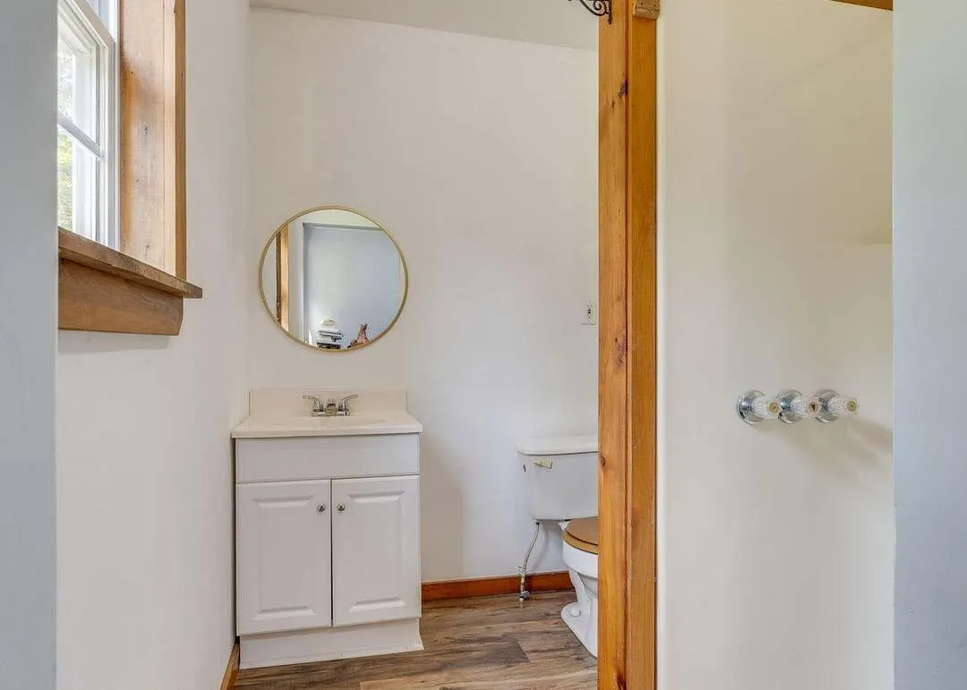 A bathroom vanity and mirror on the main level