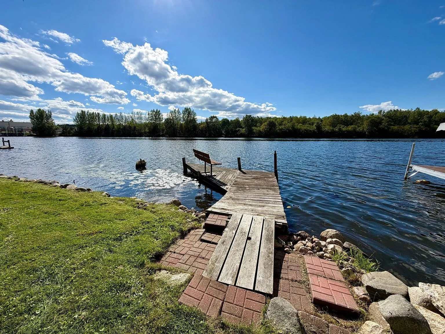 The dock reaching into the lake under a blue sky