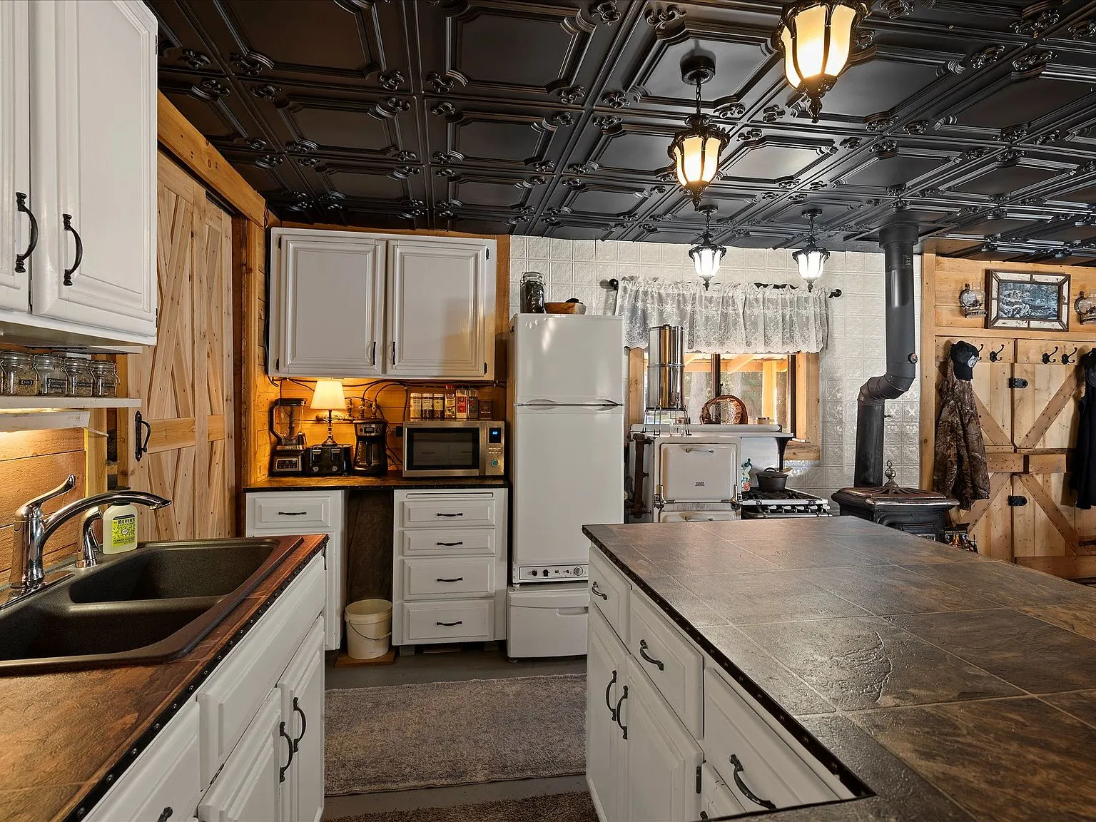 A walk-in closet with built-in shelving, hanging storage and folded linens