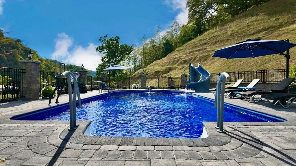 The pool and its surround with the hillside behind