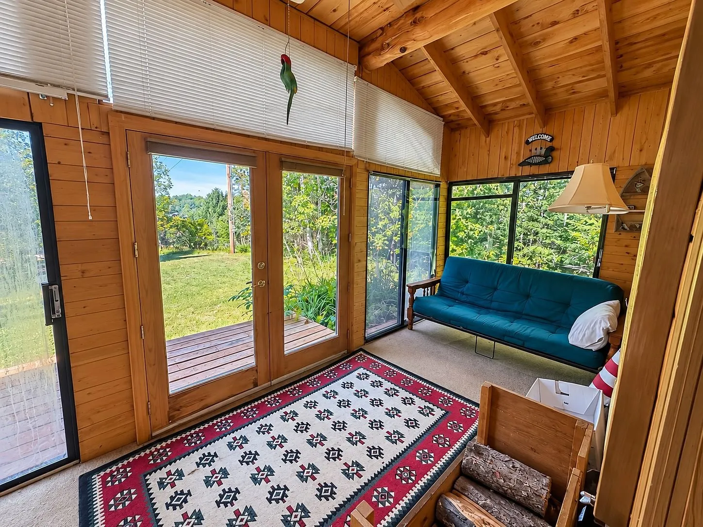 The enclosed porch with the futon and the windows onto the yard