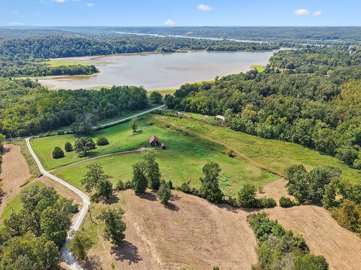 The house from the air with the bay of the Tennessee River beyond the neighboring fields