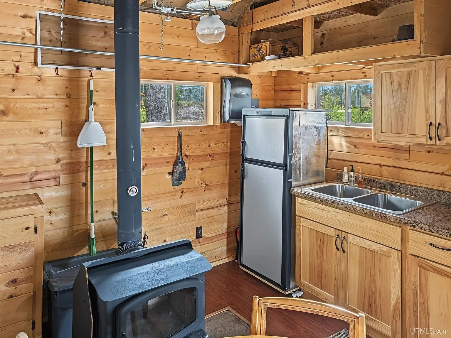 The range and counter with the wood-paneled walls