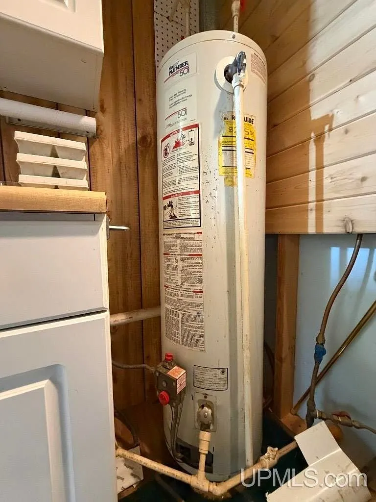The water heater and plumbing along an interior wall