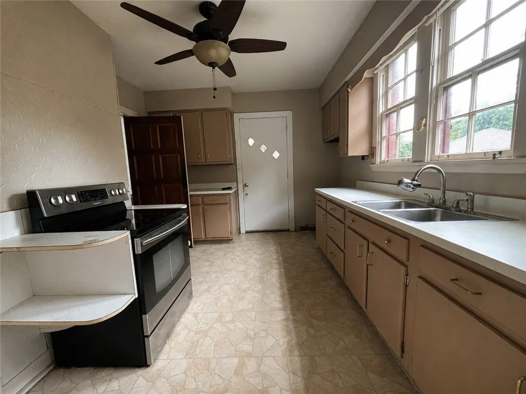 The kitchen with the electric range and the counter run