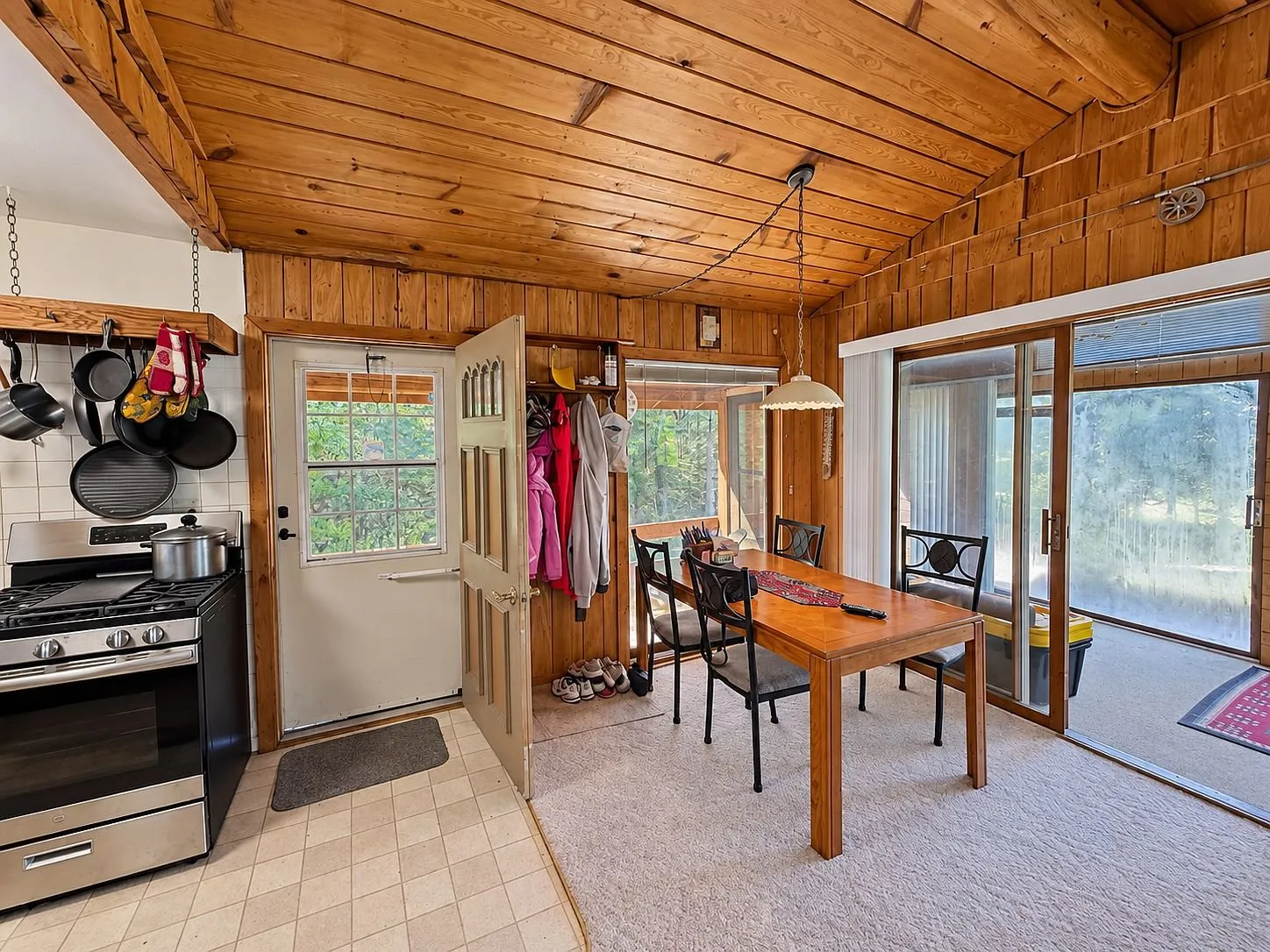 The kitchen range, the table and the door to the porch