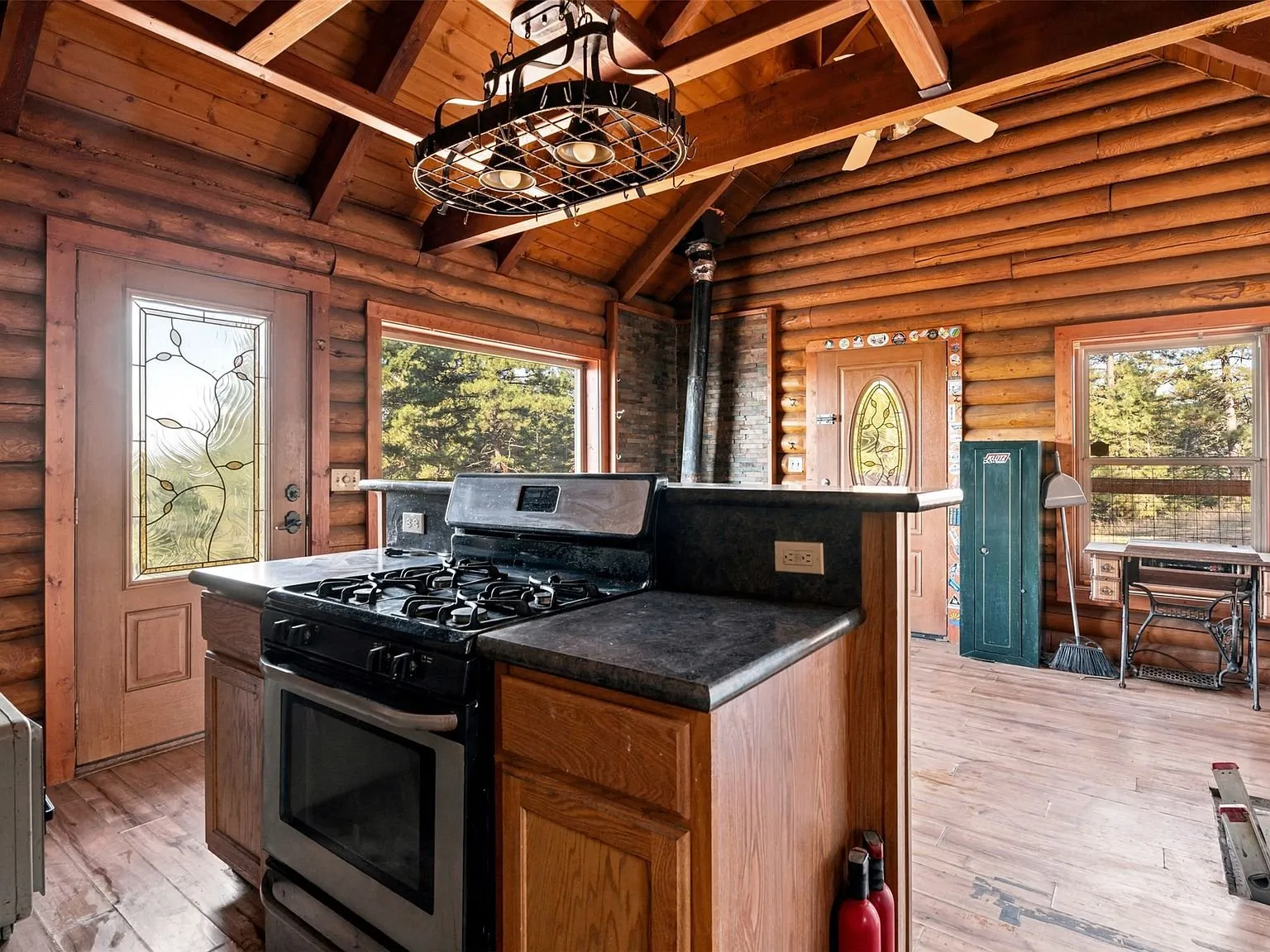 The kitchen's refrigerator and open counter space, propane tank visible against the wall