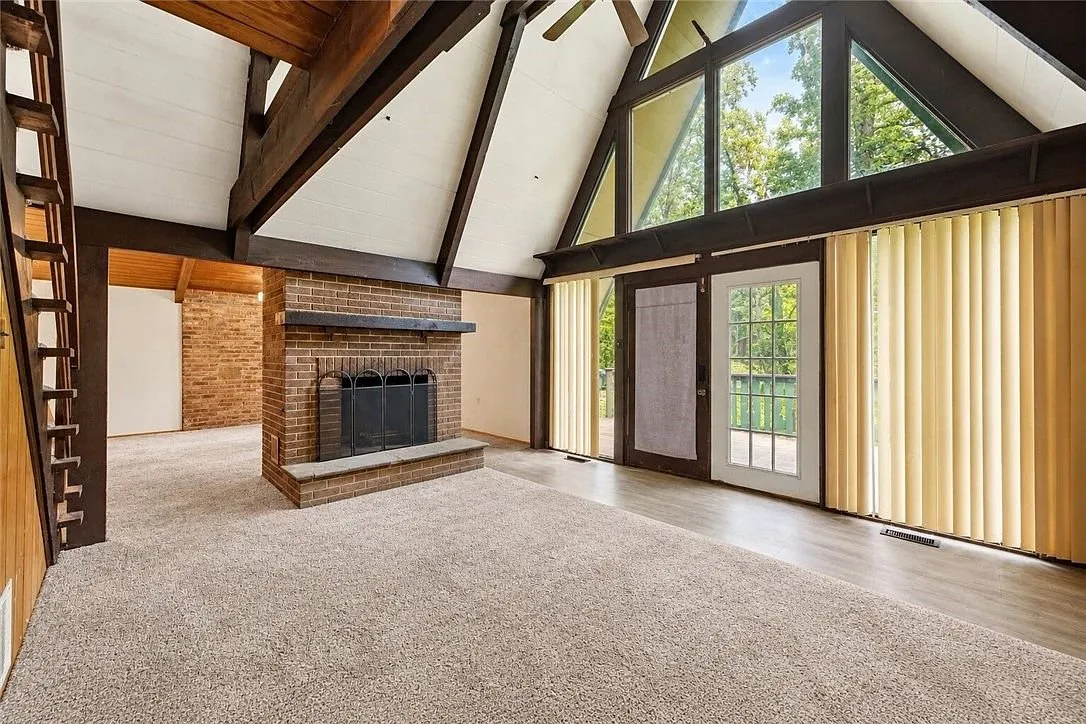 The dining area under the wood ceiling with the brick chimney chase