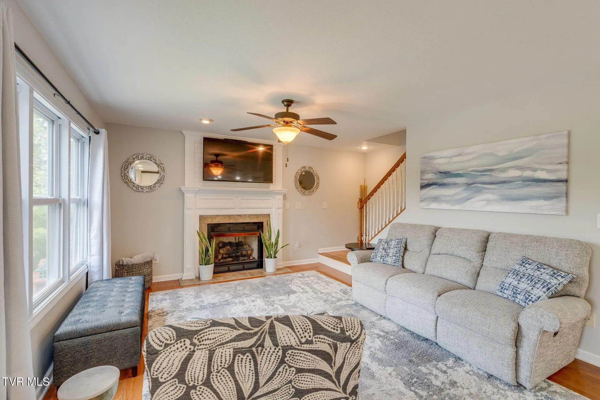 The family room with the gas log fireplace and its white mantel