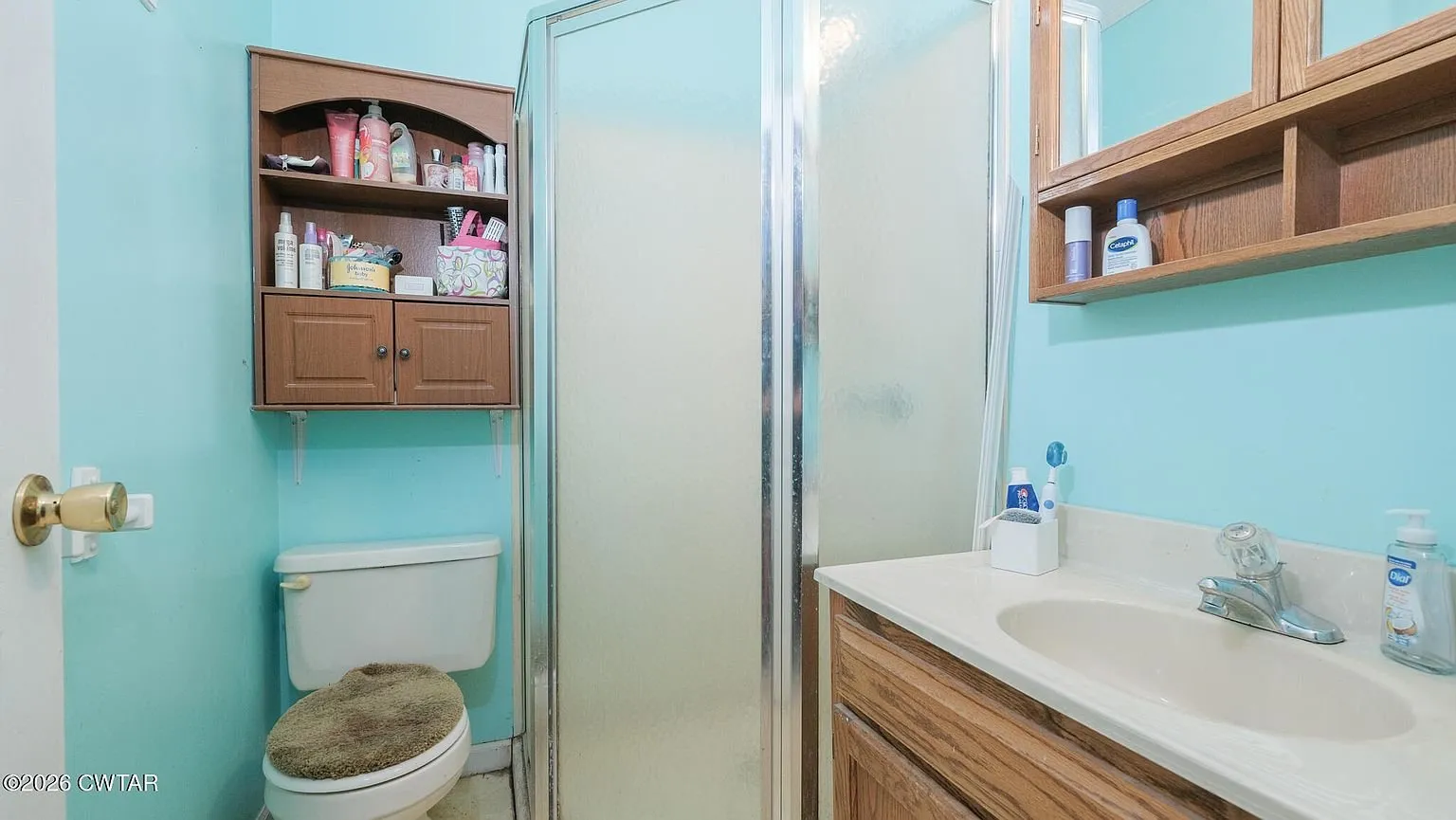 The bathroom off the main bedroom with a shower stall, toilet and vanity
