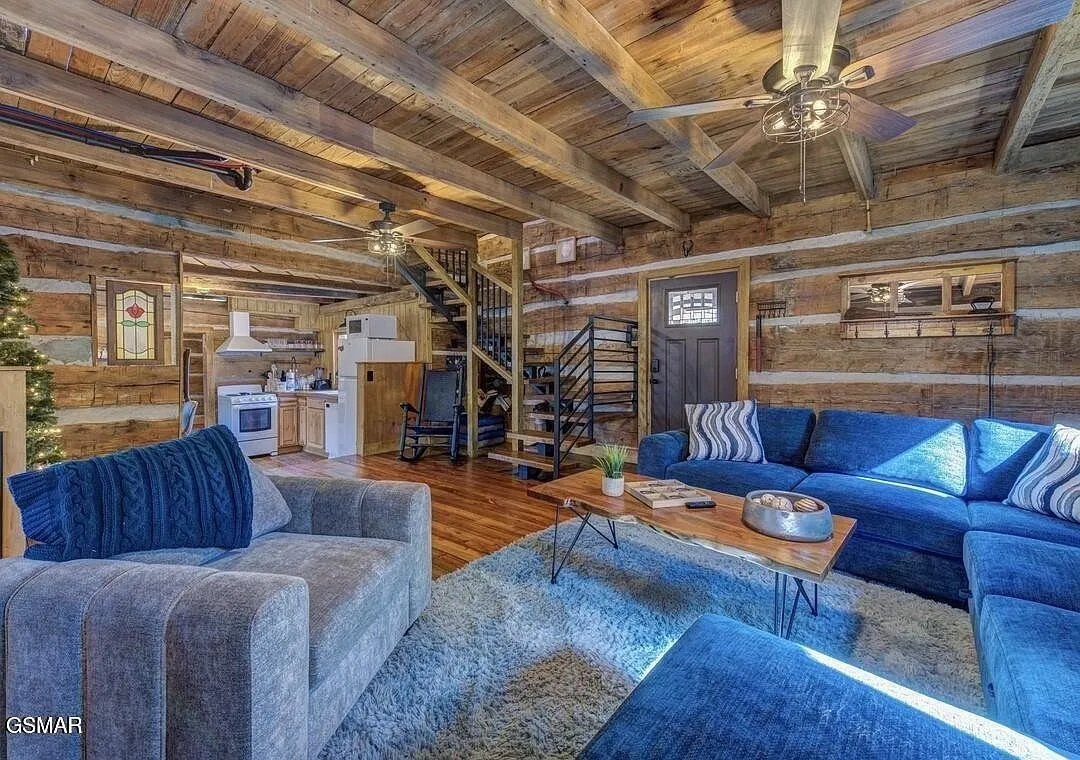 The living room from the other side showing the spiral stair to the loft