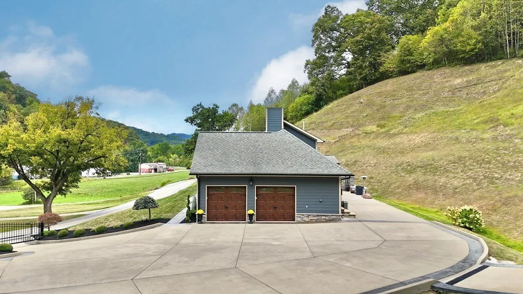 The detached garage building beside the paved drive