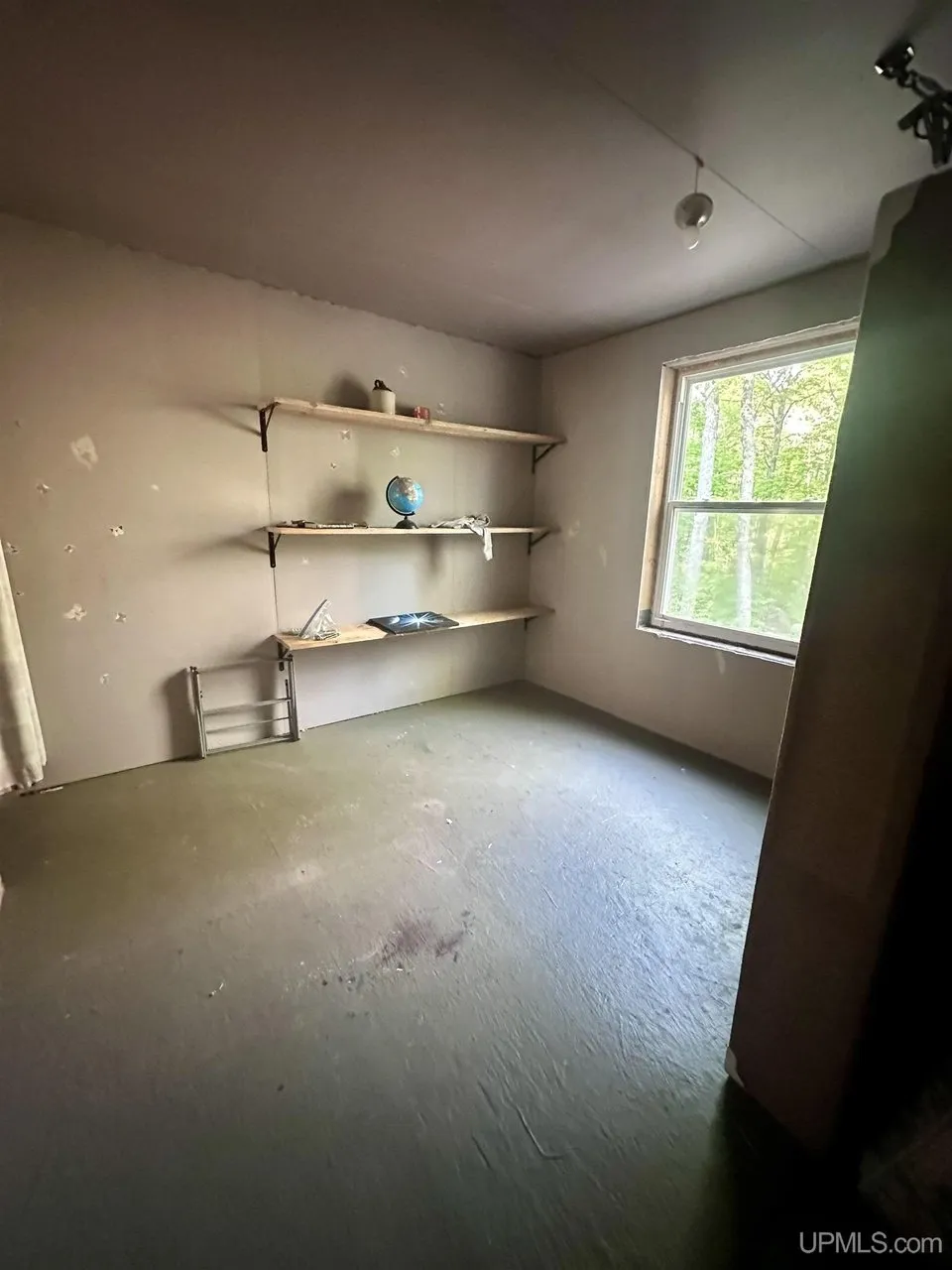 A room with open shelves and a window